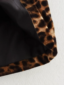 Detailed close-up of soft leopard print fabric texture and high-quality black lining
