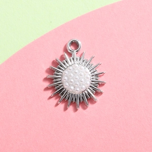 Macro detail of silver alloy snowflake pendant with inlaid pearls for DIY jewelry