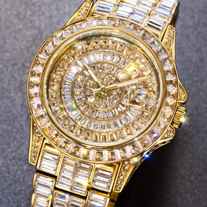 Close-up of gold tone watch featuring baguette and round cut stones with intense sparkle