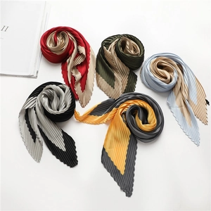 Top view of five colorful pleated scarves in elegant spiral layout with satin finish
