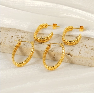 Detail of vintage gold-plated twist textured C-shape and oval hoop earring set
