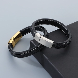 Close-up of double-layered braided leather bracelet with magnetic steel clasp in a gift box