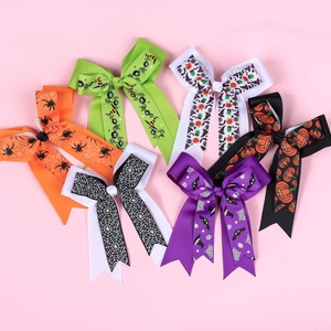 Close-up of 6 Halloween hair bows with patterns of pumpkins, spiders and ghosts