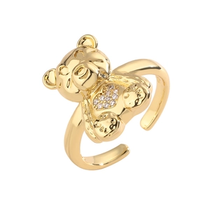 Detailed macro of gold teddy bear ring with heart shaped white zircon inlay and open band