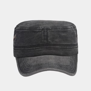 Close-up of washed cotton texture and bronze button detail on a charcoal military cap