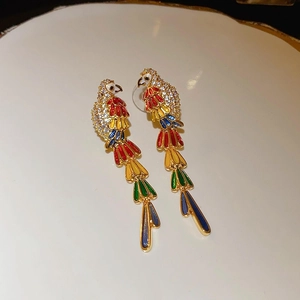 Macro shot of gold-plated parrot earrings featuring colorful enamel and inlaid zircons