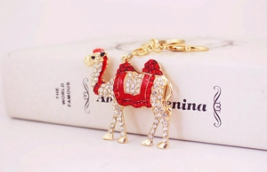 Detail of red and clear rhinestones on a gold-plated camel keychain accessory
