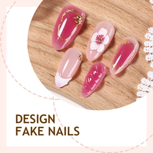 30pcs handmade floral press-on nails with pink pearls and gold accents on wood background