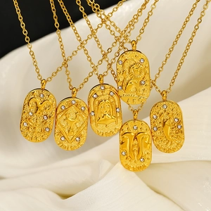 Goldene Tierkreiszeichen-Halsketten aus Edelstahl mit Zirkonia auf weißem Stoffgewebe