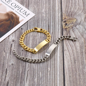Top view of gold and silver cuban link id bracelets on rustic wood background