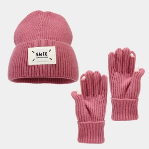 Detail of pink knitted set showing fingertip openings on gloves and woven brand label