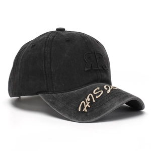 Detail of washed black baseball cap featuring 3D RR patch and gold brim embroidery