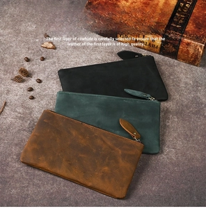 Three vintage mad horse leather wallets in black, dark green, and brown shown stacked