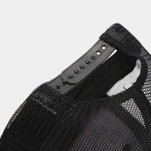 Detail of adjustable snapback closure and breathable mesh texture on the black cap