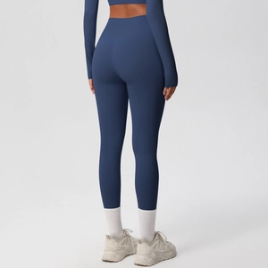 Macro view of high-waist yoga leggings showing dark blue fabric texture and push-up effect