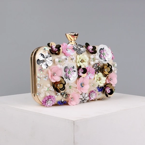Detailed close-up of champagne evening bag with colorful 3D floral beads and sequins