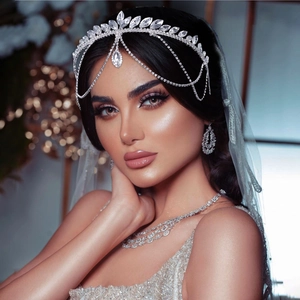 Detailed close-up of bridal crystal crown with teardrop pendants and matching earrings