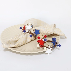 Patriotic USA napkin rings with red white blue stars and berries on a white plate