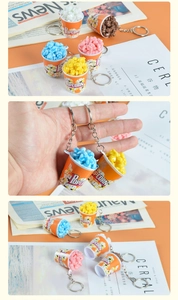 Detailed view of colorful realistic popcorn bucket keychains on stylish magazines