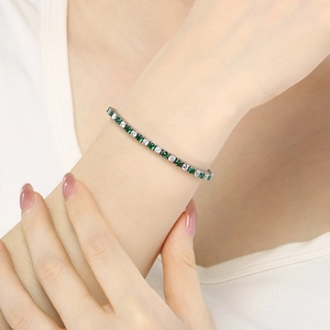 Adjustable stainless steel tennis bracelet with sparkling green and white cubic zirconia