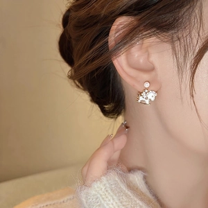 Elegant gold plated rocking horse earrings with pearls and zircons worn by model