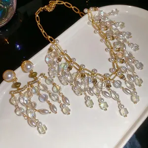 Luxury pearl and crystal fringe necklace and earring set with golden tassel design