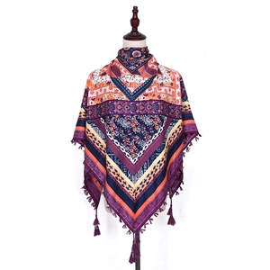 Detail of bohemian jacquard scarf featuring ethnic floral patterns and knotted tassels