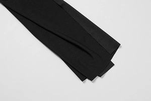 Detail of premium black fabric with subtle sheen and high-density texture on mini dress