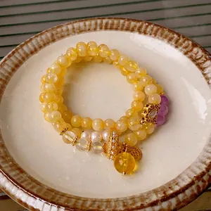 Elegant multi-layer yellow citrine and pearl bracelet with golden Fu character charm
