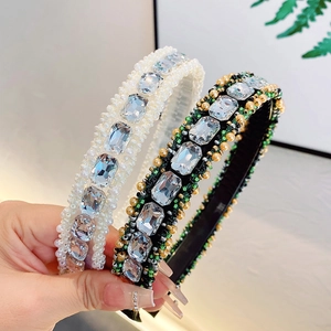 Sparkling rhinestone headband featuring large crystals and pearls for elegant hair styling