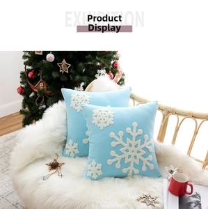 Detail of light blue velvet pillow covers with 3D white snowflake embroidery decor
