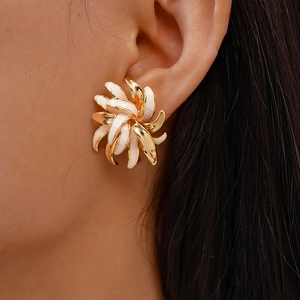 Close-up of a model wearing a gold and white enamel flower stud earring for women