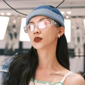 Y2K futuristic transparent sunglasses with pink reflective lenses worn with denim miki hat