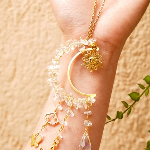 Detail of sun catcher bracelet with natural crystal stones and celestial charms