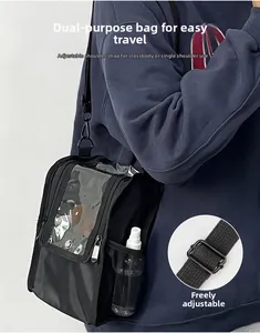 Detail of adjustable shoulder strap and side mesh pocket on a black makeup bag