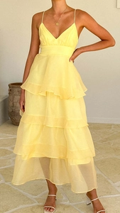 Detail view of yellow V-neck tiered chiffon evening dress with layered cake skirt