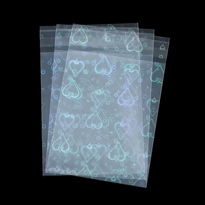Detail of holographic OPP self-sealing bags with heart patterns for jewelry packaging