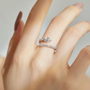 Detail of S925 silver ring with pear-cut stone and pavé setting on a hand