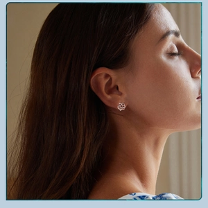 Close-up of a silver Celtic knot hollow stud earring worn on a model's earlobe