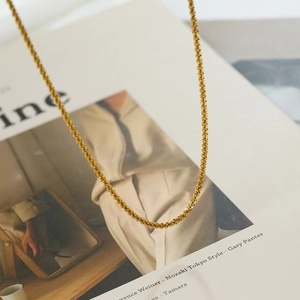 Gleaming 18K gold-plated stainless steel star necklace with spiral textured chain link
