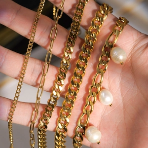 Detail showing five gold stainless steel chain styles including cable, paperclip, and cuban links