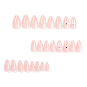Short almond press on nails in pale pink with white ribbon bows and micro rhinestones