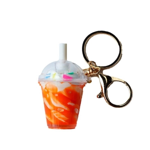 Miniature orange sundae ice cream keychain with colorful sprinkles and golden metal ring