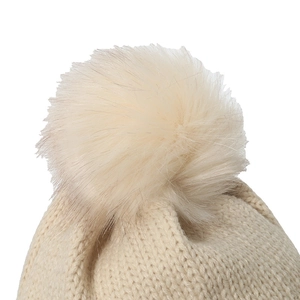Cute beige winter knitted hat featuring a fluffy pom-pom and bow detail for women