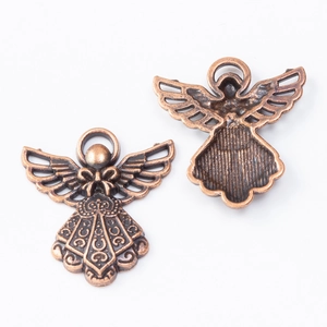 Macro view of vintage bronze angel charms showing detailed front and back textures