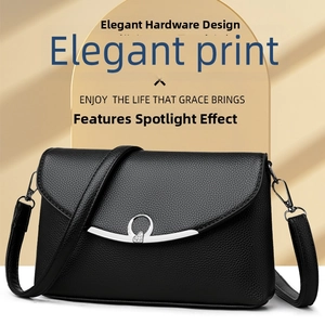 Detail of black litchi grain leather bag with elegant silver heart buckle hardware