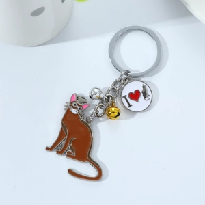 Close-up of cat keychain with brown enamel pendant, golden bells and I love cat tag