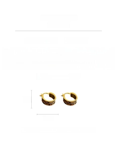 Detail showing vintage gold-plated C-shaped enamel earrings with animal print pattern