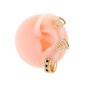 Gold heart and star cartilage earrings set with cubic zirconia on a pink ear model
