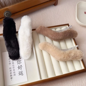 Set of four plush faux fur hair clips in black, white, brown and tan displayed in a grid